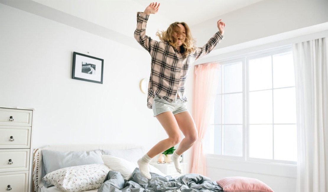 Girl  jumping on bed
