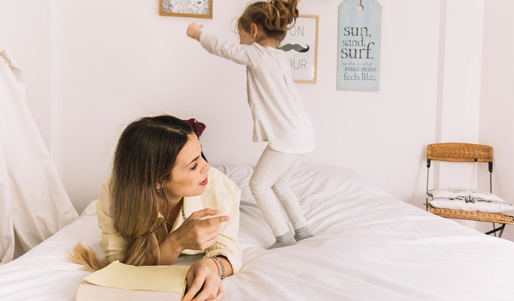 mother telling child not to jump on the bed