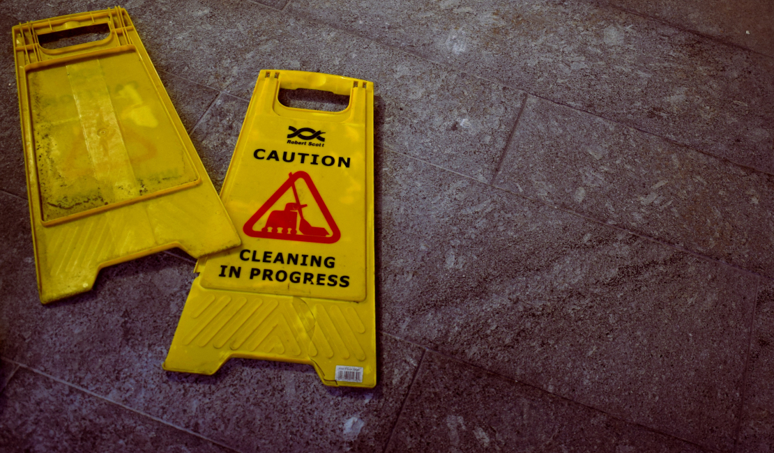 Cleaning in progress warning sign lying on the floor.