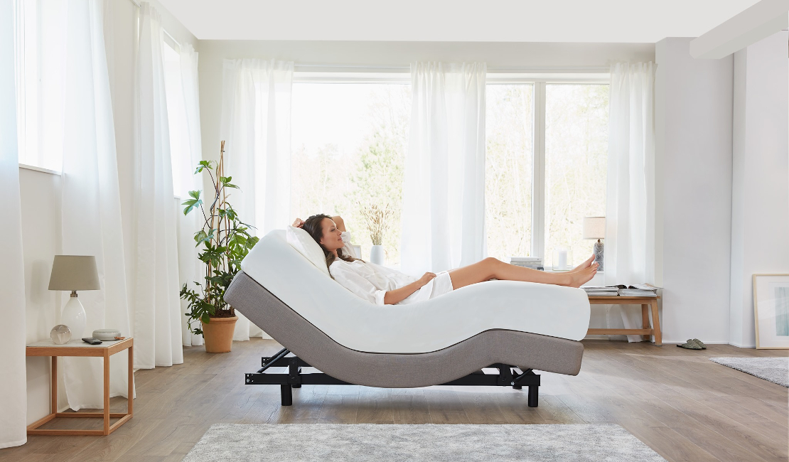 The Tempur Flex 2000 bed with a lady relaxing on it. 