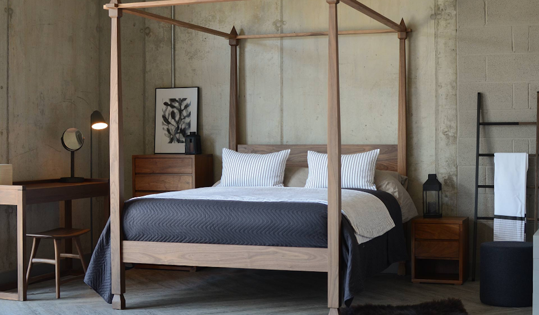 Four poster beds can be used in many settings, like this industrial meets traditional bedroom. 