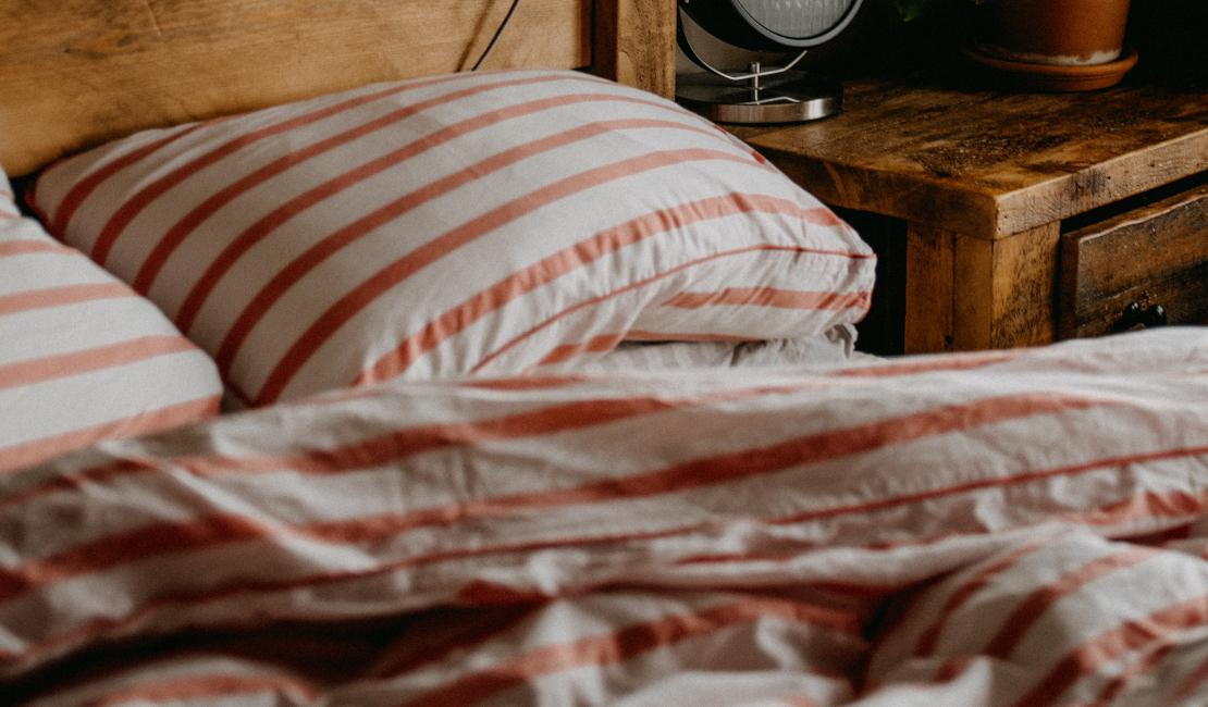 Orange and white striped duvet cover sets go well with rustic wooden furniture.
