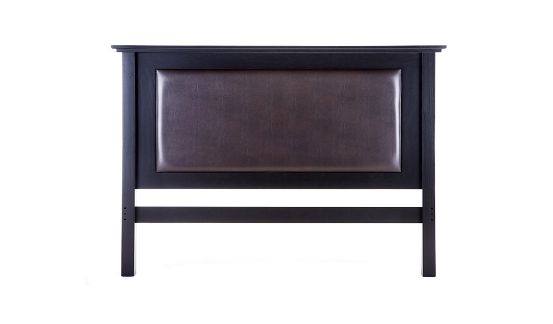 A dark chocolate brown leather rectangle offset against a darker, almost black wooden headboard frame. 