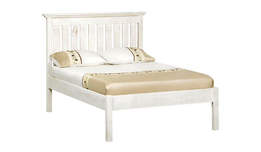 Whitewashed wooden platform bed with beige and white linen on top.