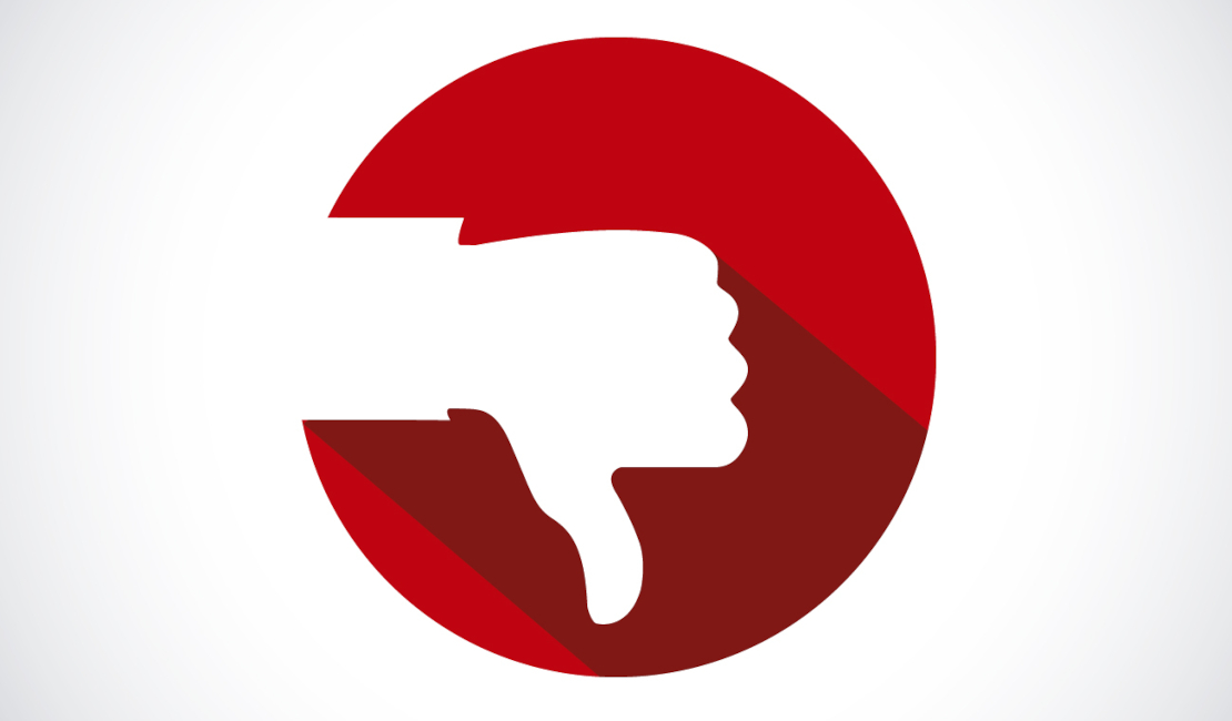 White thumbs down sign in a red circle against a white background.